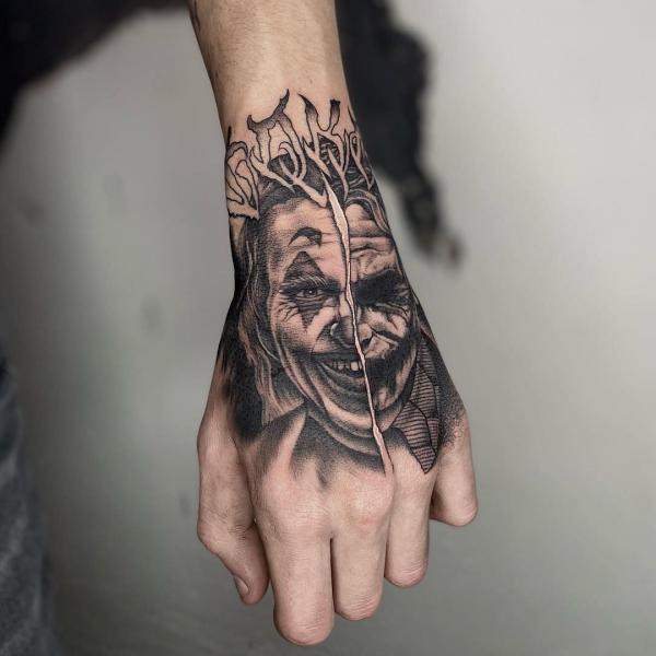 Joker hand tattoo black and grey