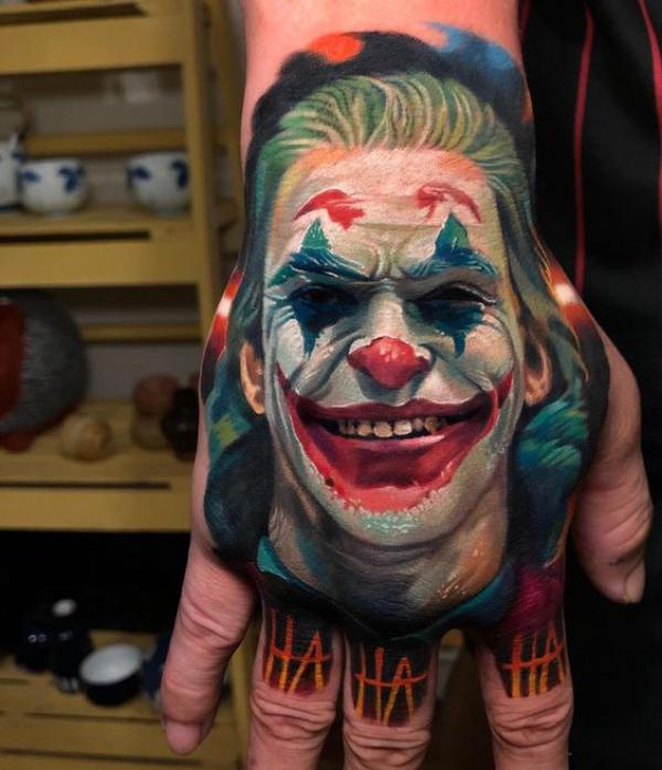 Joker portrait hand tattoo