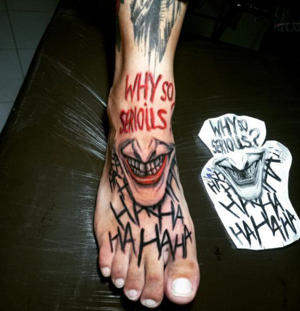 Joker smile with words Why so serious and hahaha foot tattoo