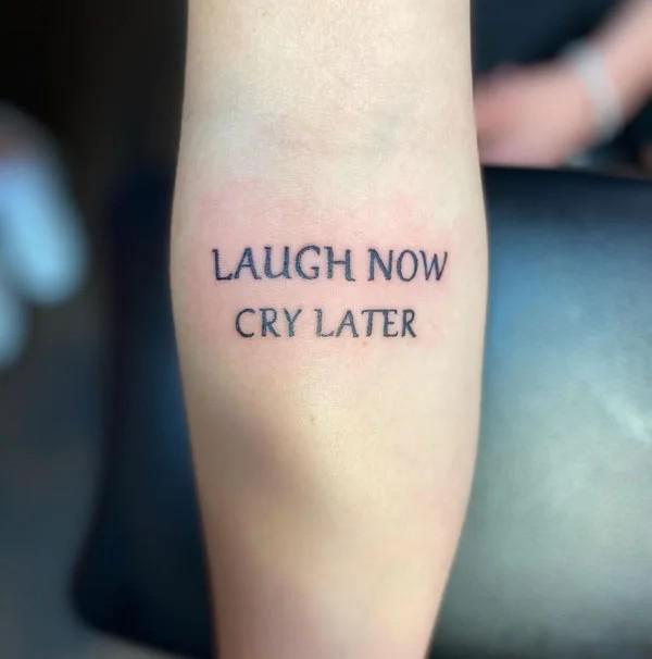 Laugh now cry later lettering tattoo
