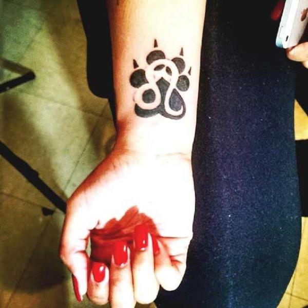 Leo and paw print wrist tattoo