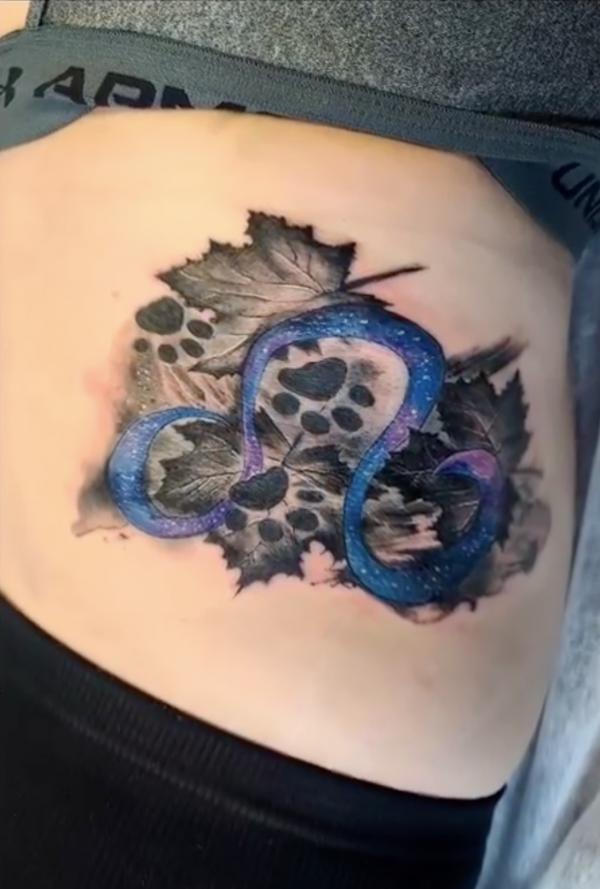 Leo glyph and leaves with paw print tattoo