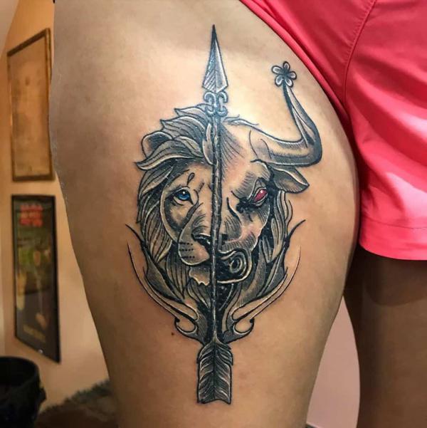 Leo lion and Sagittarius arrow thigh tattoo