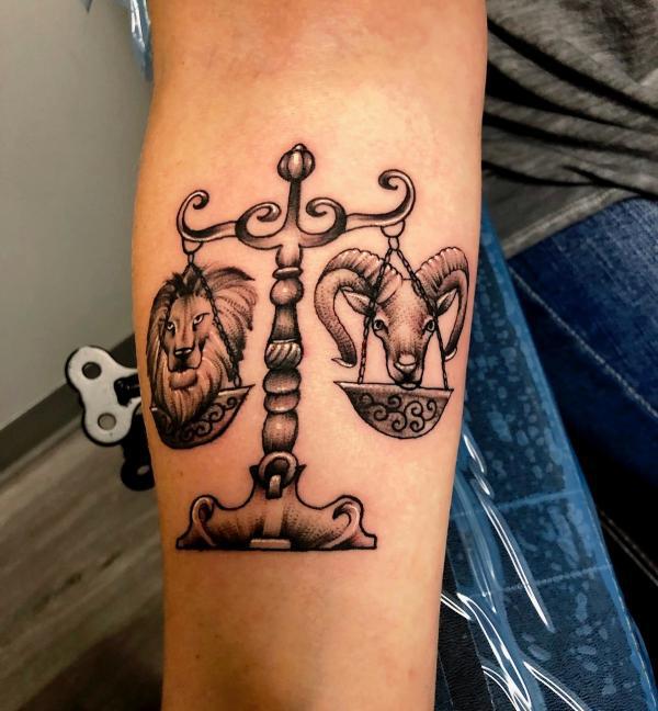 Libra scales with Leo lion and Aries Ram tattoo