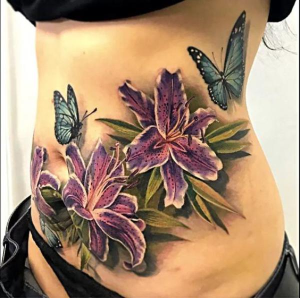 Lily and butterfly stomach tattoo
