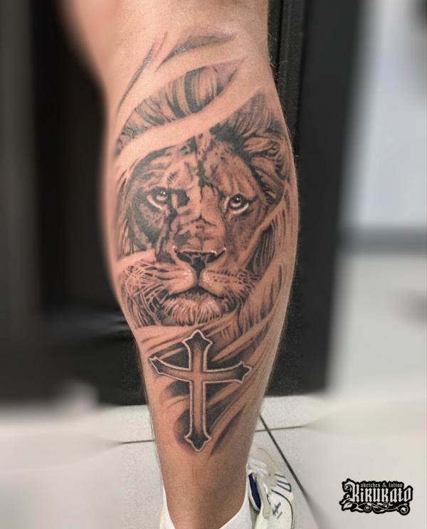 Lion and cross calf tattoo
