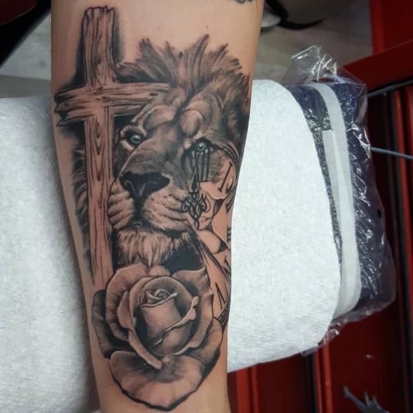 Lion and cross with rose tattoo