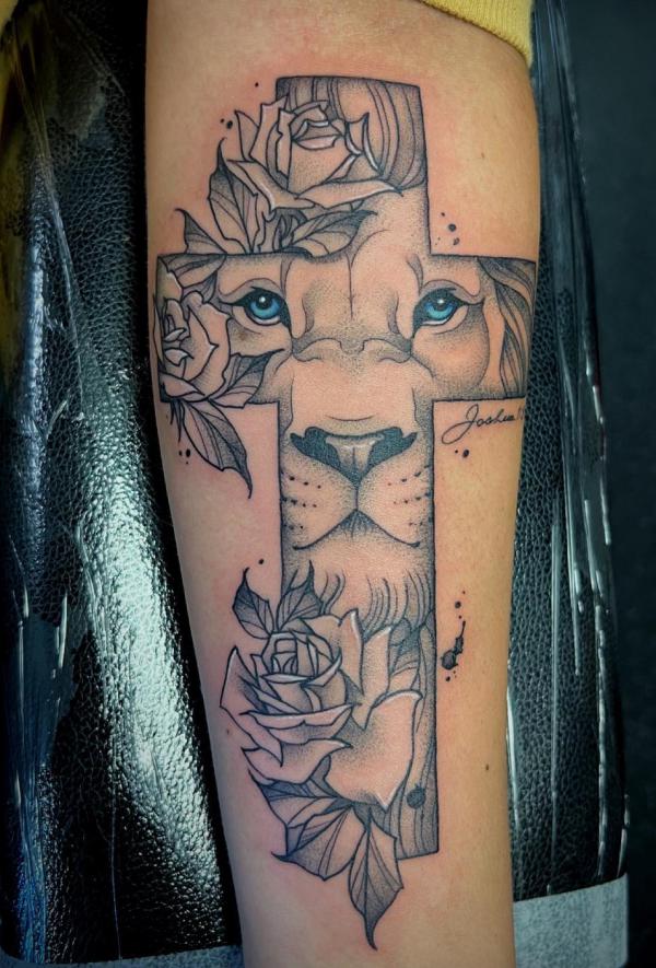 Lion face cross with roses tattoo