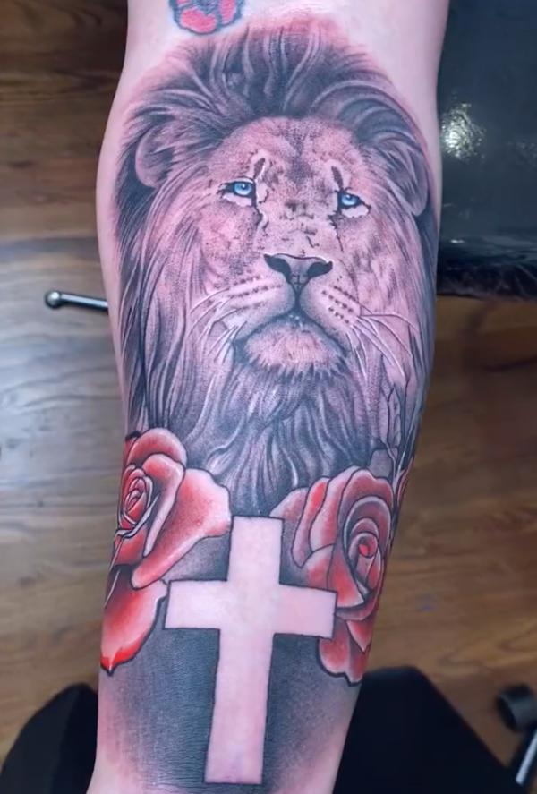 Lion king with cross and red rose tattoo