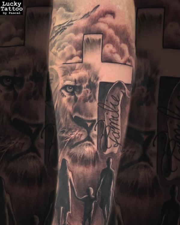 Lion with cross and family tattoo