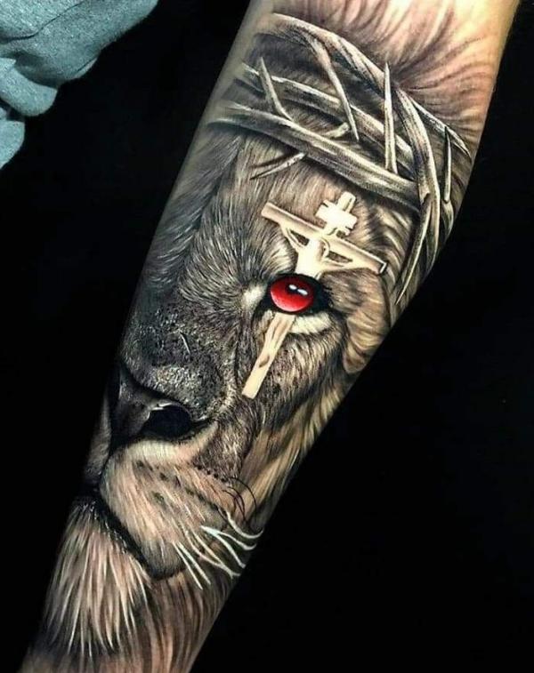Lion with cross on red eye tattoo