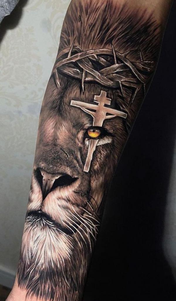 Lion with cross on yellow eye tattoo
