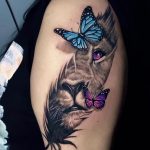 Lioness face with butterfly and purple eye tattoo