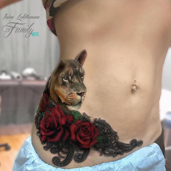 Lioness with rose side belly tattoo