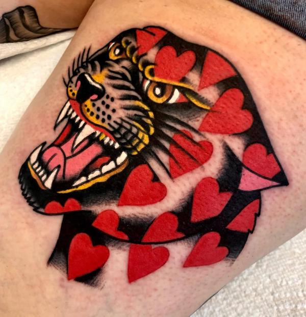 Love heart panther tattoo on thigh