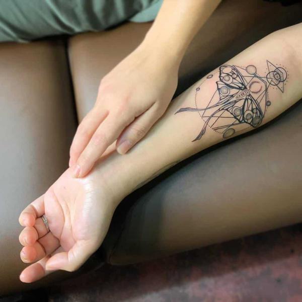 Luna moth with moon phases line work tattoo