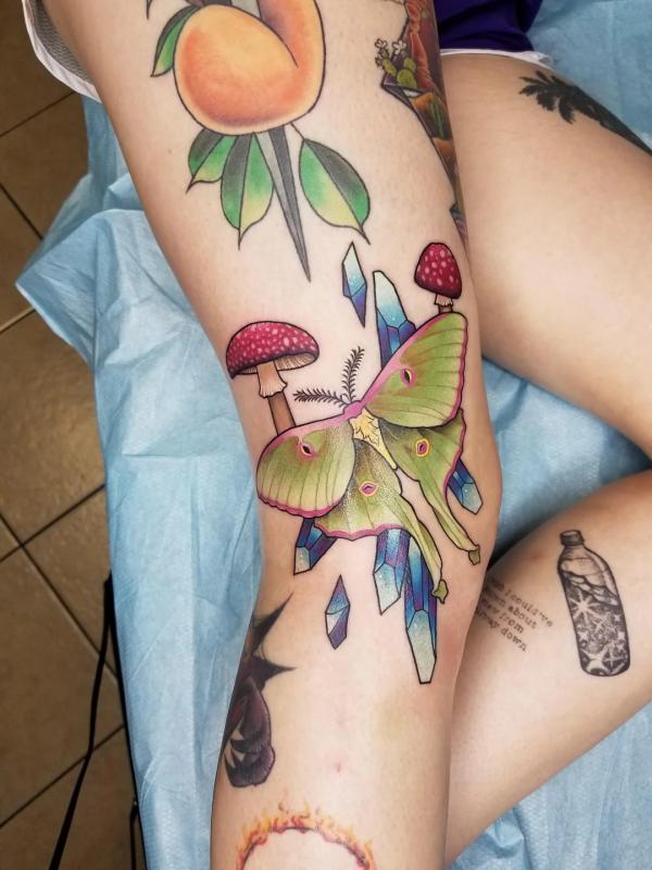 Luna moth with mushroom crystal and peach tattoo on leg