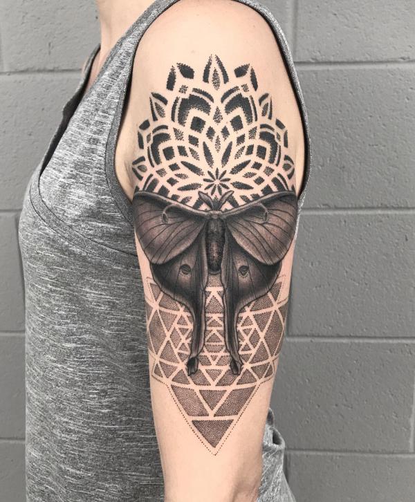 Mandala and geometric luna moth blackwork tattoo