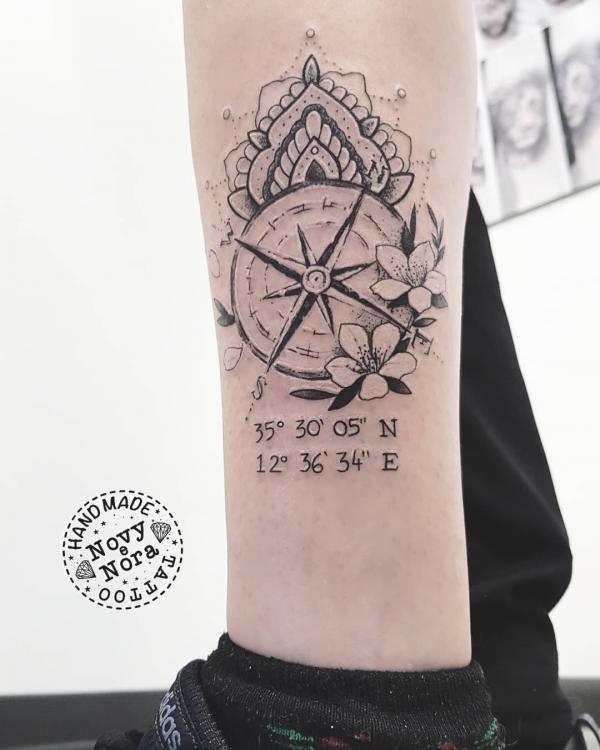 Mandala compass with flower and coordinates tattoo