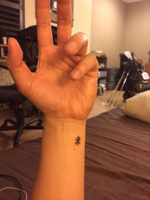 Minimalist Chi Rho wrist tattoo