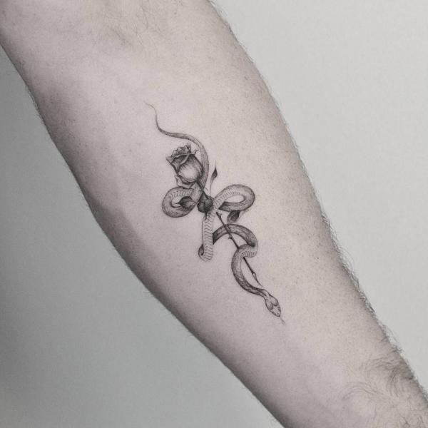 Minimalist rose and snake tattoo forearm