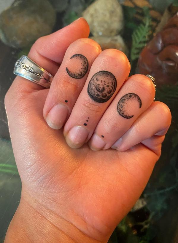 Moon phase tattoo on fingers