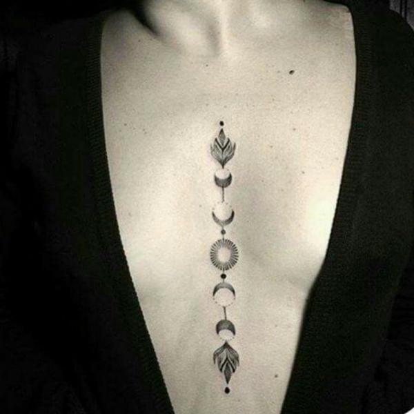 Moon phase with sun sternum tattoo
