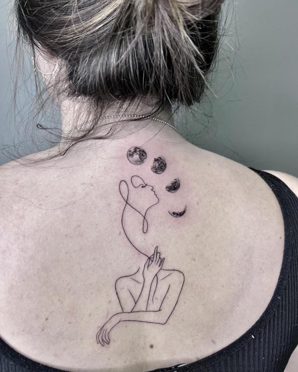 Moon phases and surreal woman line work tattoo