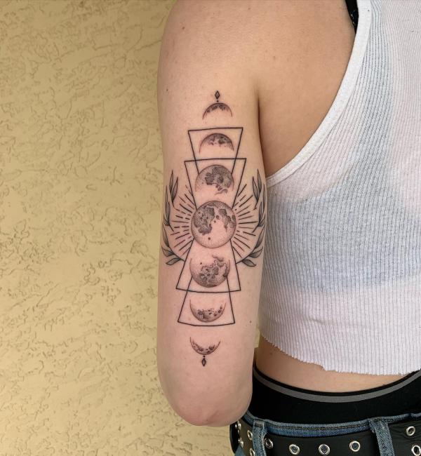 Moon phases back of arm tattoo