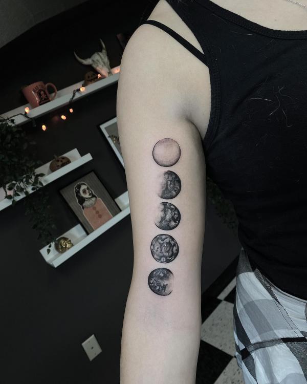 Moon phases bicep tattoo