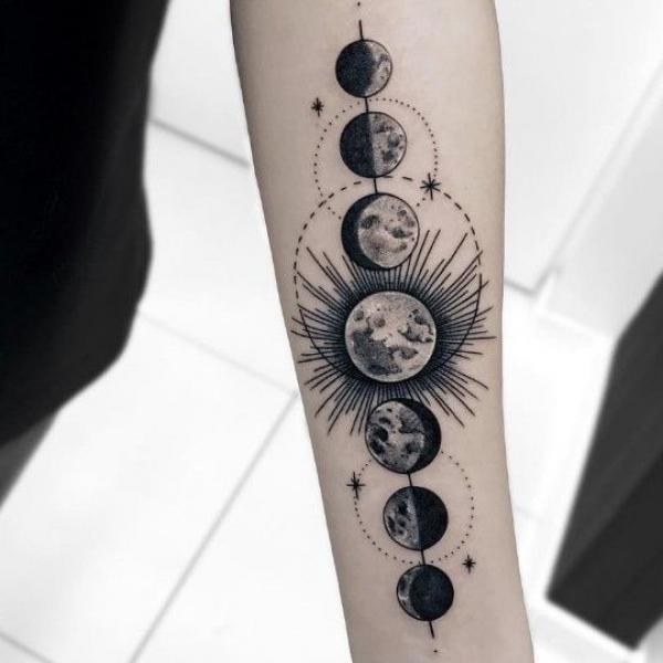 Moon phases forearm tattoo