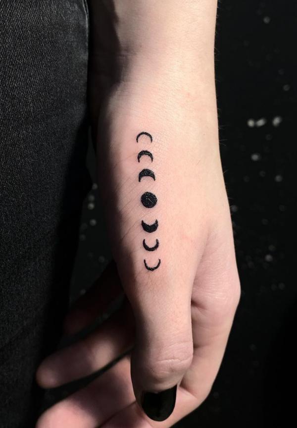 Moon phases thumb finger tattoo