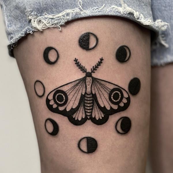 Moon phases with moth tattoo on thigh