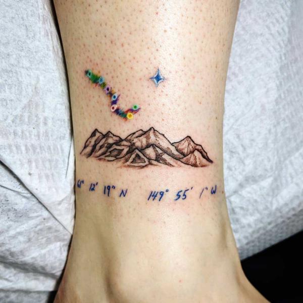 Mountain and stars with coordinates tattoo