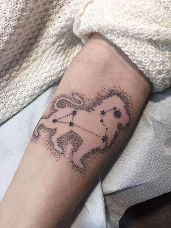 Negative space lion with Leo constellation tattoo