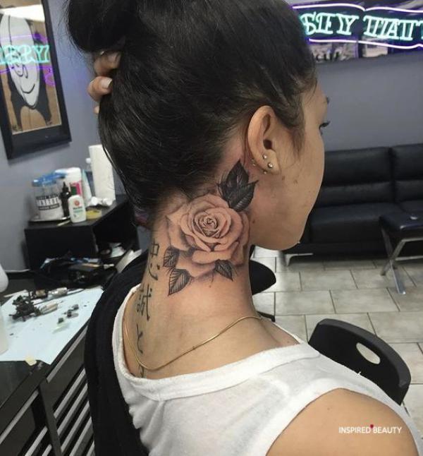 Negative space rose tattoo on the side of neck
