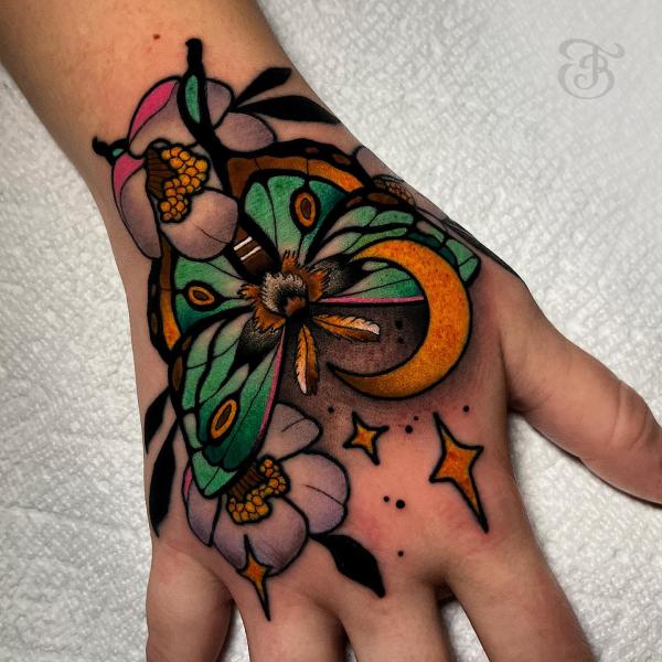 Neo traditional luna moth with crescent moon handtattoo
