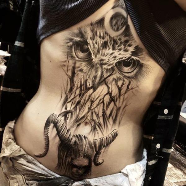 Owl and ram headdress abdomen tattoo