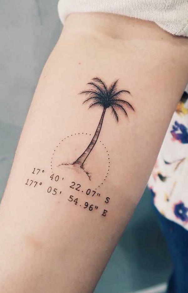Palm tree with coordinates tattoo on forearm
