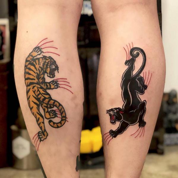 Panther and tiger fighting tattoo