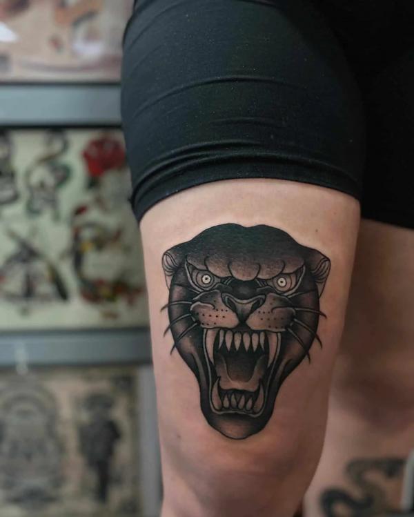 Panther head knee tattoo traditional