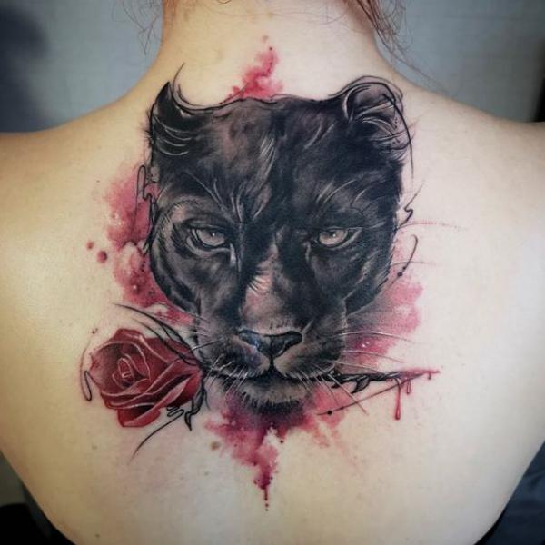 Panther holding a rose in mouth tattoo
