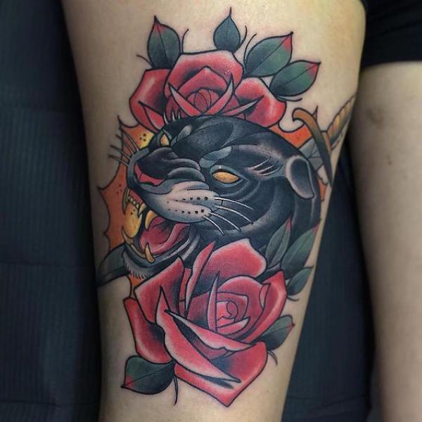 Panther in roses thigh tattoo