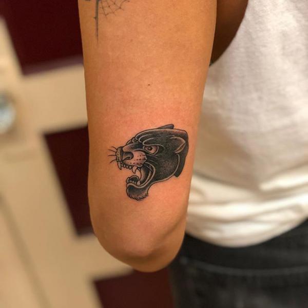 Panther tattoo above elbow
