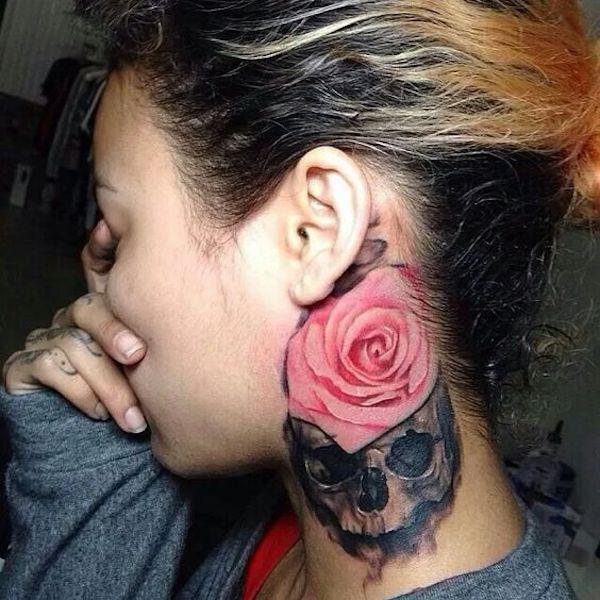 Pink rose and dark skull tattoo on the side of neck