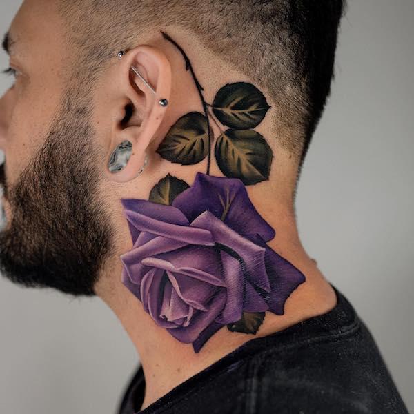 Purple rose tattoo upside down on neck