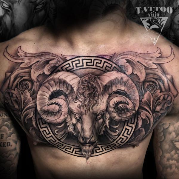 Ram head with greek key and flowers chest tattoo for men