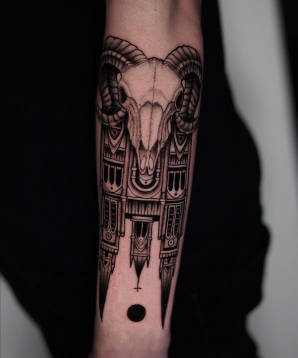 Ram skull and church tattoo on forearm