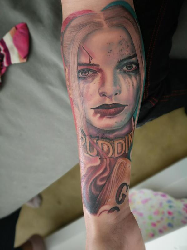 Realistic Harley Quinn forearm tattoo
