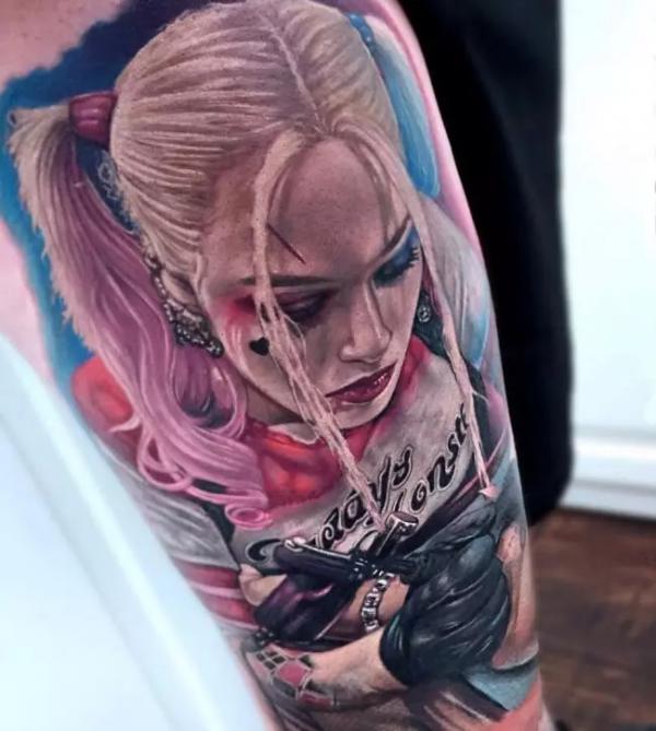 Realistic Harley Quinn looking down tattoo half sleeve